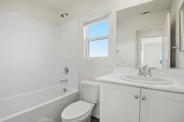 a bathroom with a sink toilet vanity and bathtub