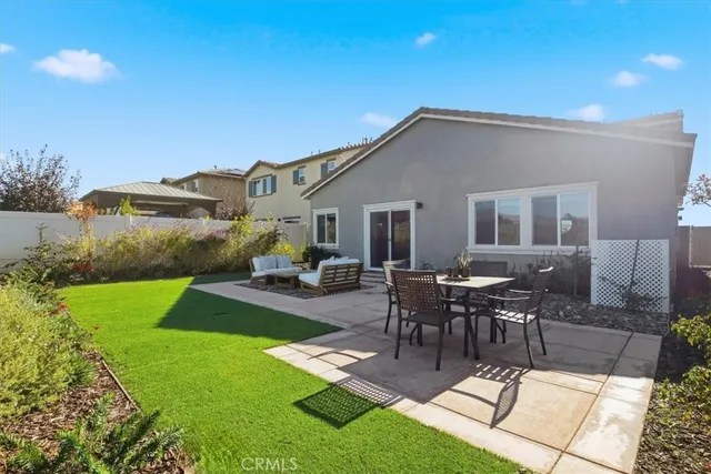 a view of a house with backyard and sitting area