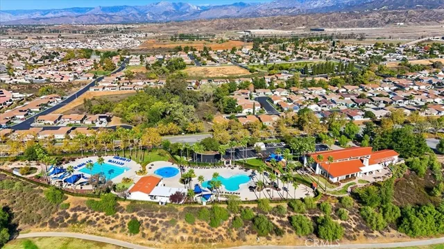 an aerial view of residential houses with outdoor space and street view