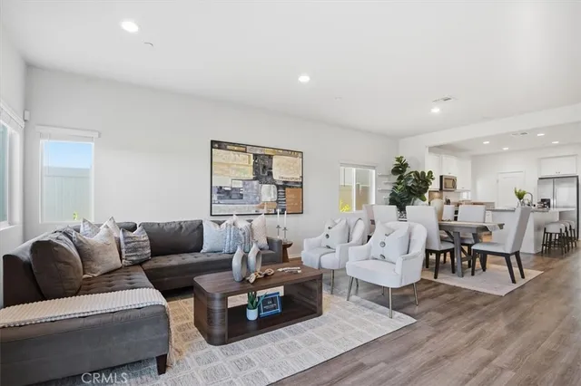 a living room with furniture wooden floor and a table