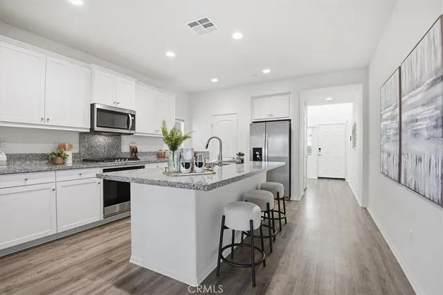 a kitchen with sink cabinets and stainless steel appliances