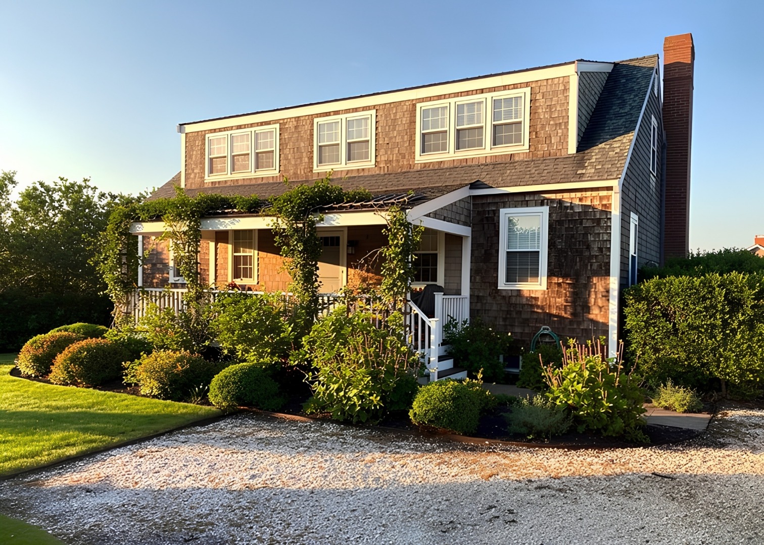 78 Baxter Road Nantucket, MA 02554 - Photo 2 of 14 a front view of a house with garden
