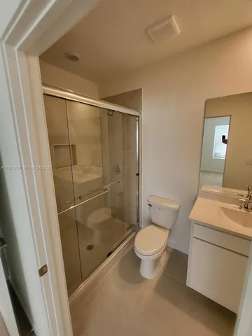a bathroom with a shower a toilet and a sink