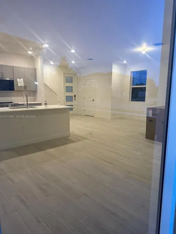 a bathroom with a sink a large mirror and shower