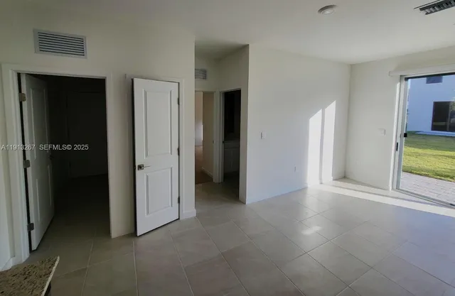 an empty room with closet and a bathroom