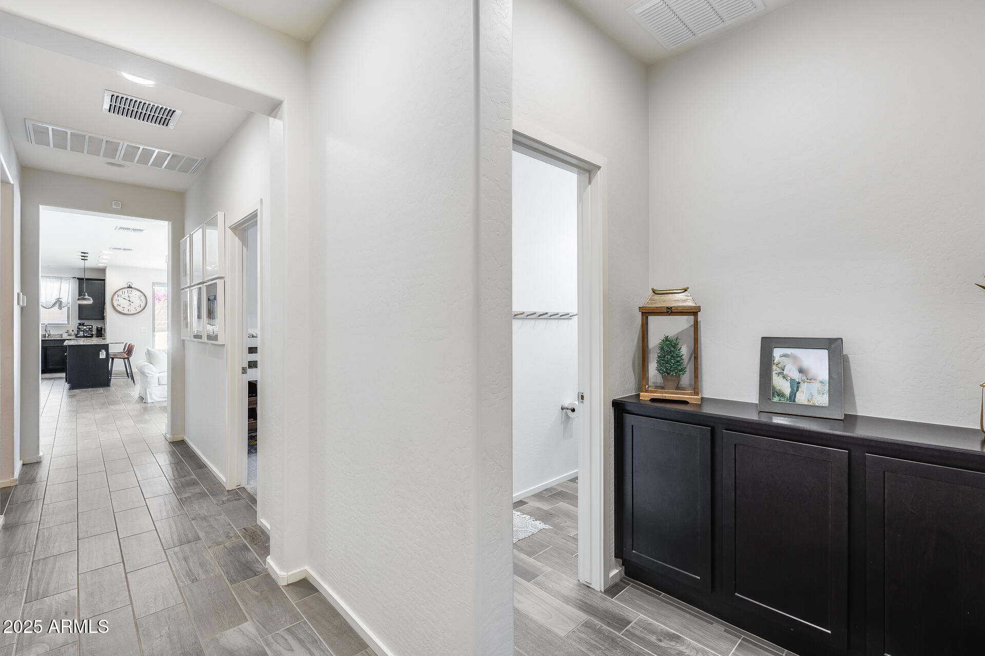 14344 West Hackamore Drive Surprise, AZ 85387 - Photo 14 of 41 a view of a hallway with wooden floor windows and a livingroom
