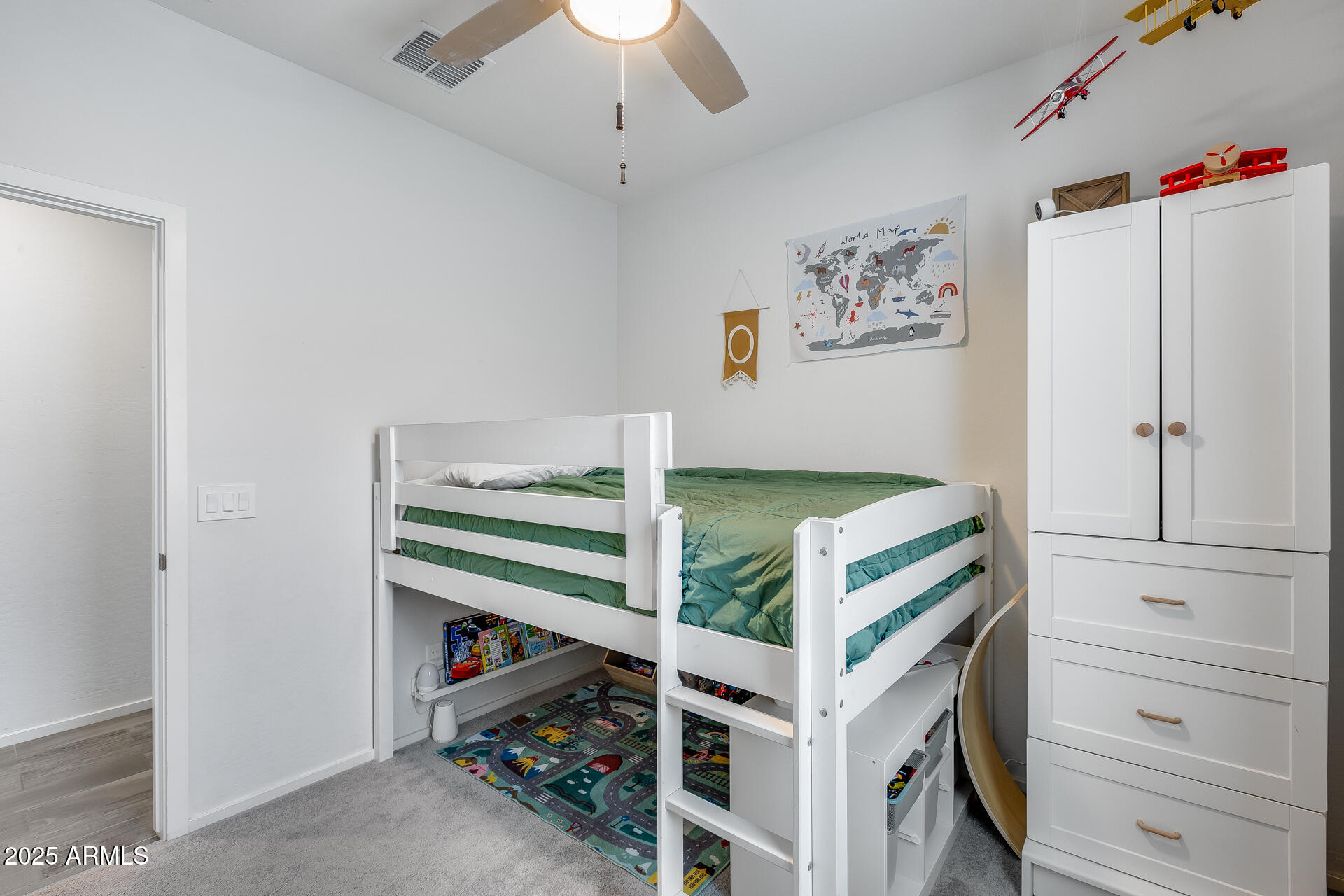 14344 West Hackamore Drive Surprise, AZ 85387 - Photo 16 of 41 a view of a bedroom with baby bed and storage