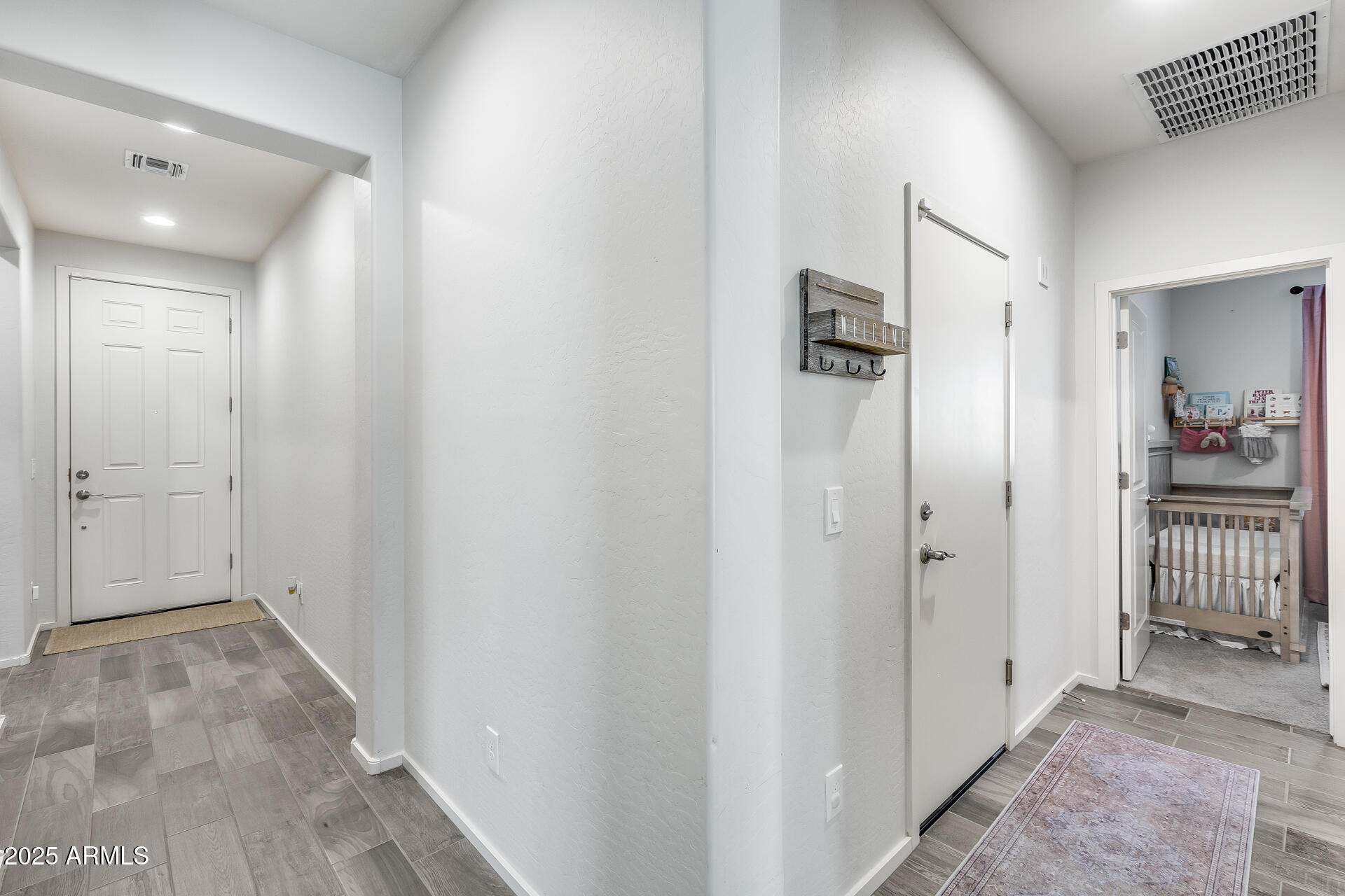 14344 West Hackamore Drive Surprise, AZ 85387 - Photo 17 of 41 a view of a hallway with wooden shelves