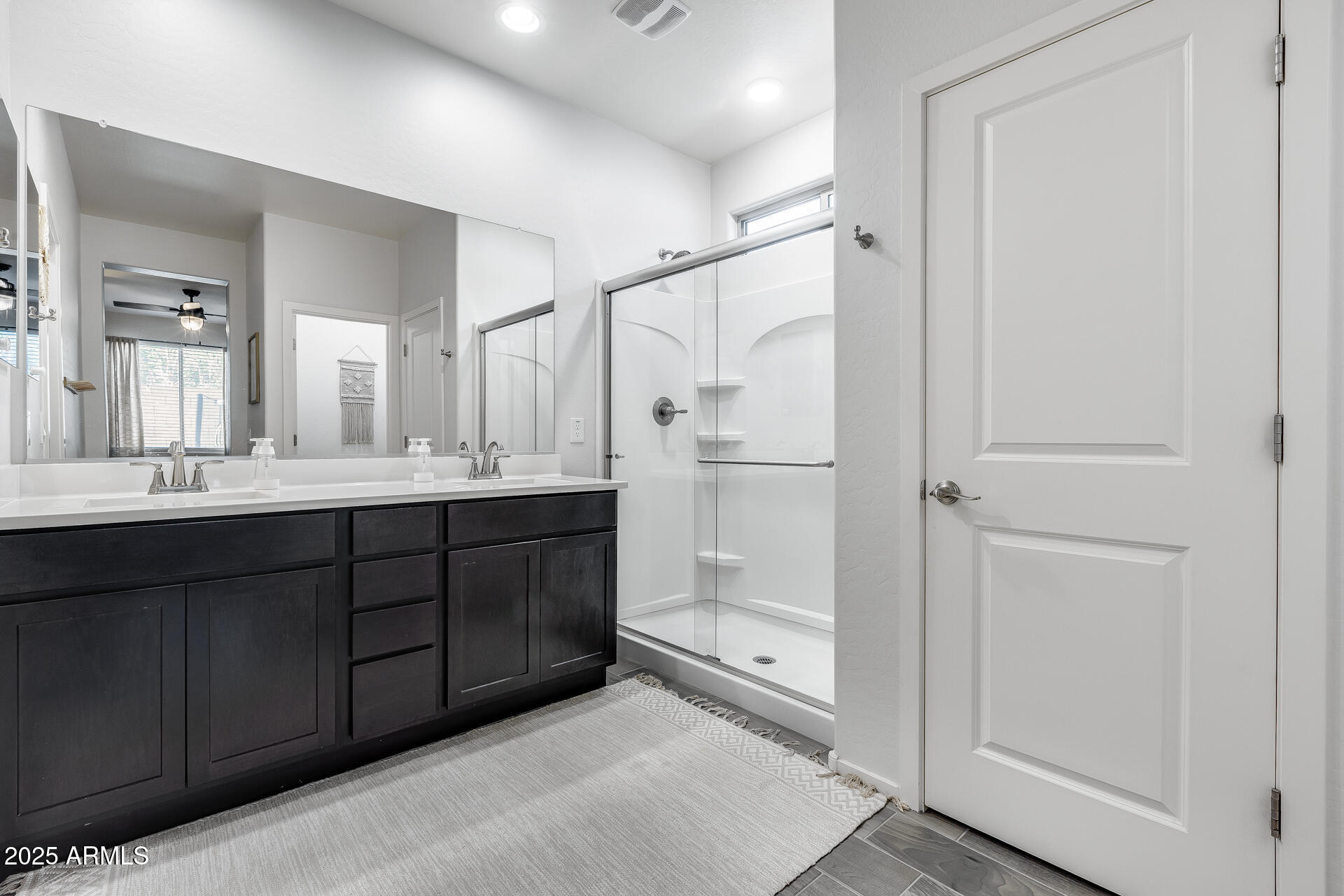 14344 West Hackamore Drive Surprise, AZ 85387 - Photo 33 of 41 a bathroom with a double vanity sink mirror and shower