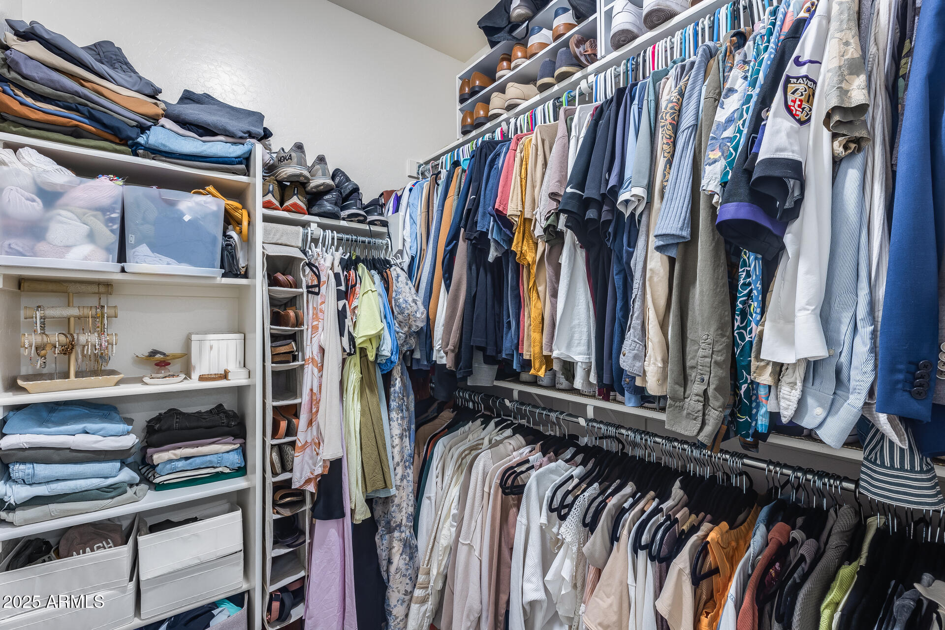 14344 West Hackamore Drive Surprise, AZ 85387 - Photo 34 of 41 a view of walk in closet with clothes and shoes