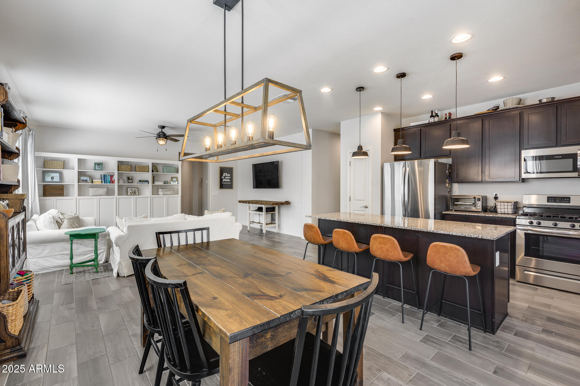 14344 West Hackamore Drive Surprise, AZ 85387 - Photo 3 of 41 a view of a dining room with furniture and wooden floor