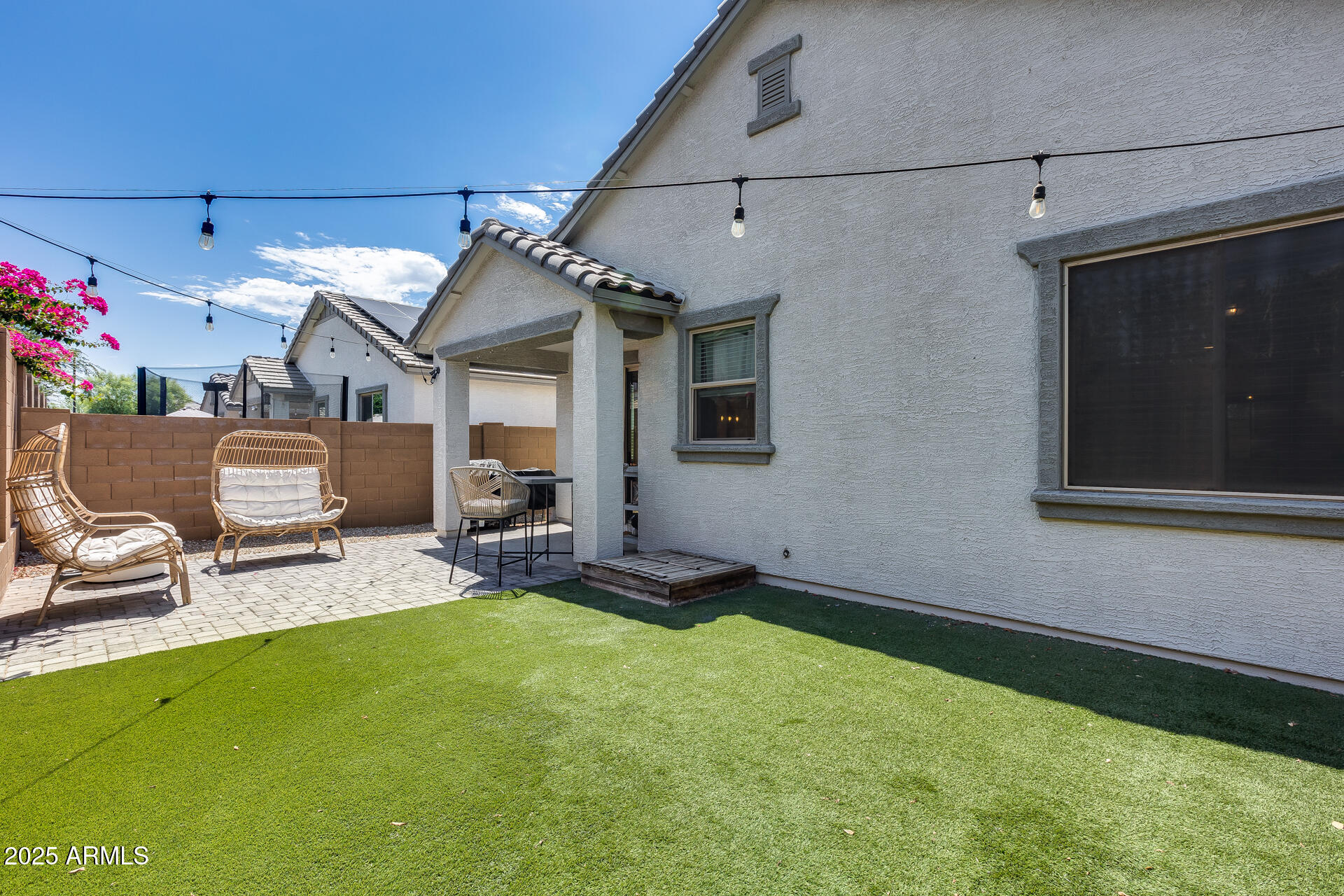 14344 West Hackamore Drive Surprise, AZ 85387 - Photo 5 of 41 a view of a patio with table and chairs a barbeque and wooden fence