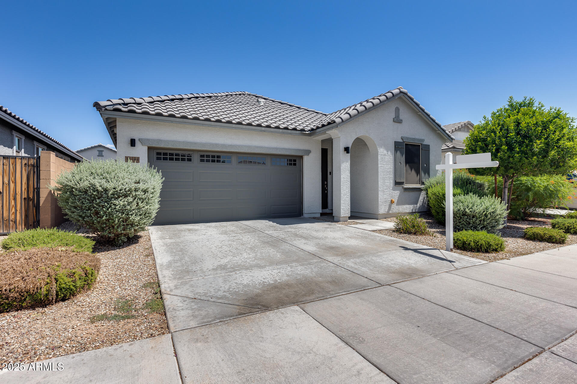 14344 West Hackamore Drive Surprise, AZ 85387 - Photo 6 of 41 a front view of a house with a garden and plants