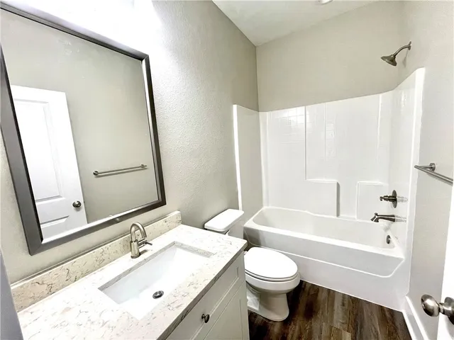 a bathroom with a bathtub and toilet