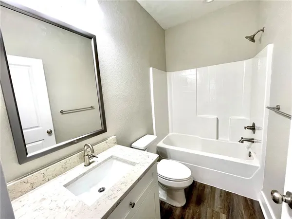 a bathroom with a bathtub and toilet