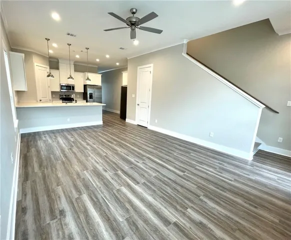 a kitchen with kitchen island a sink stainless steel appliances and cabinets