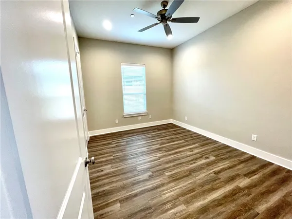 a view of a room with wooden floor and staircase