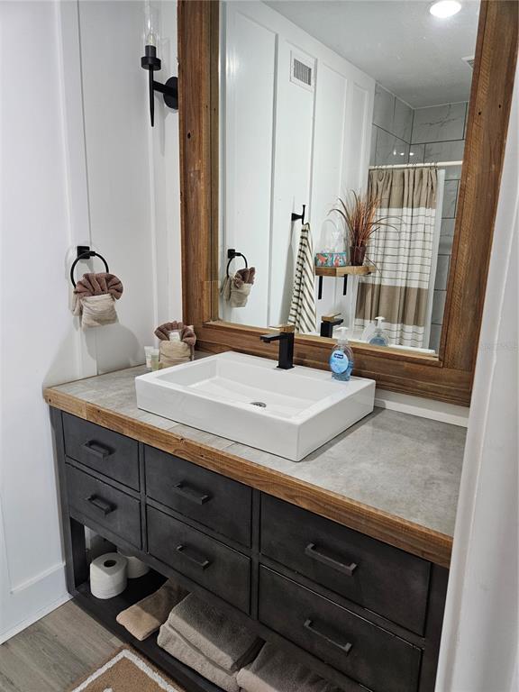 42 Menendez Road St. Augustine, FL 32080 - Photo 17 of 31 a bathroom with a granite countertop sink and a mirror
