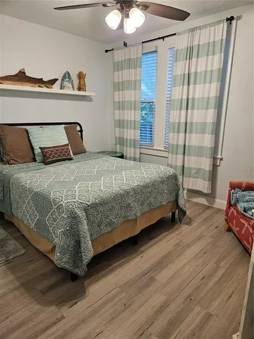 a bedroom with a bed and a flat tv screen