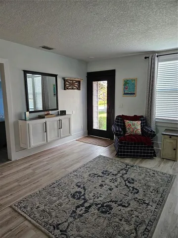 a living room with furniture window and wooden floor