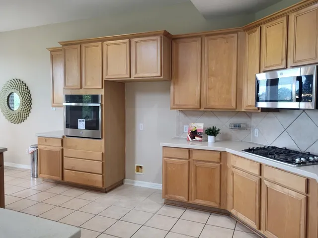 a kitchen with a cabinets and window