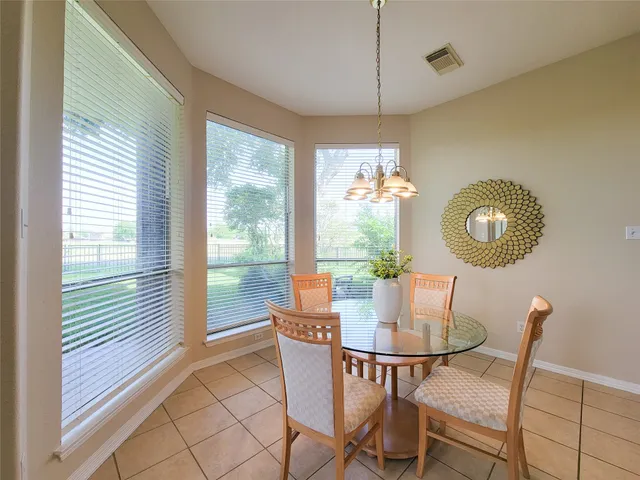 a dining room with furniture and window