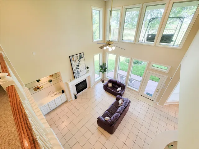 a living room with furniture and a floor to ceiling window