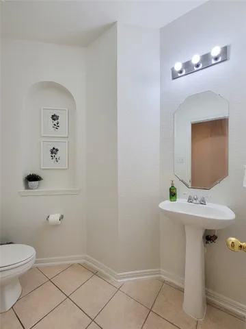 a bathroom with a sink mirror and toilet
