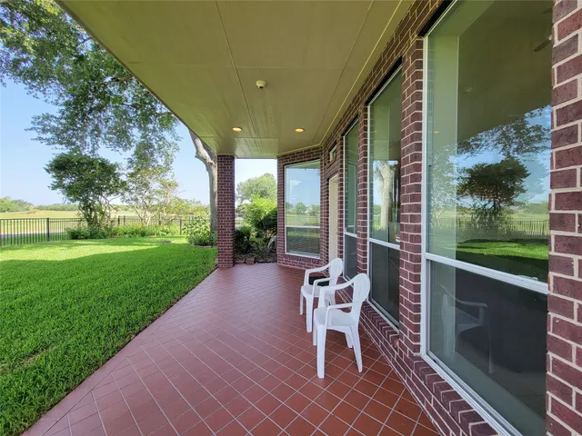 a building outdoor space with patio furniture and garden