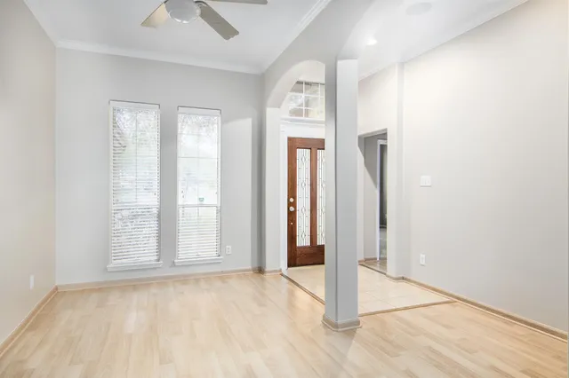 an empty room with windows and closet