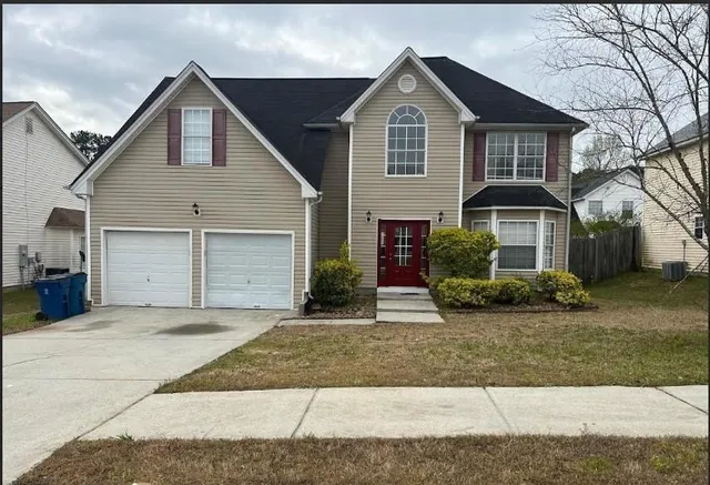 a front view of a house with a yard and garage