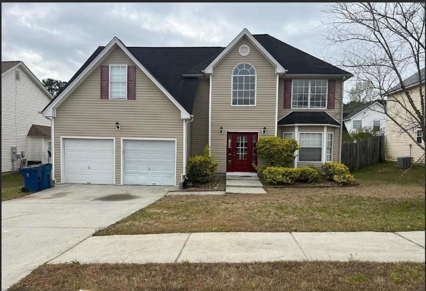 1256 Partridge Lane Riverdale, GA 30296 - Photo 1 of 1 a front view of a house with a yard and garage