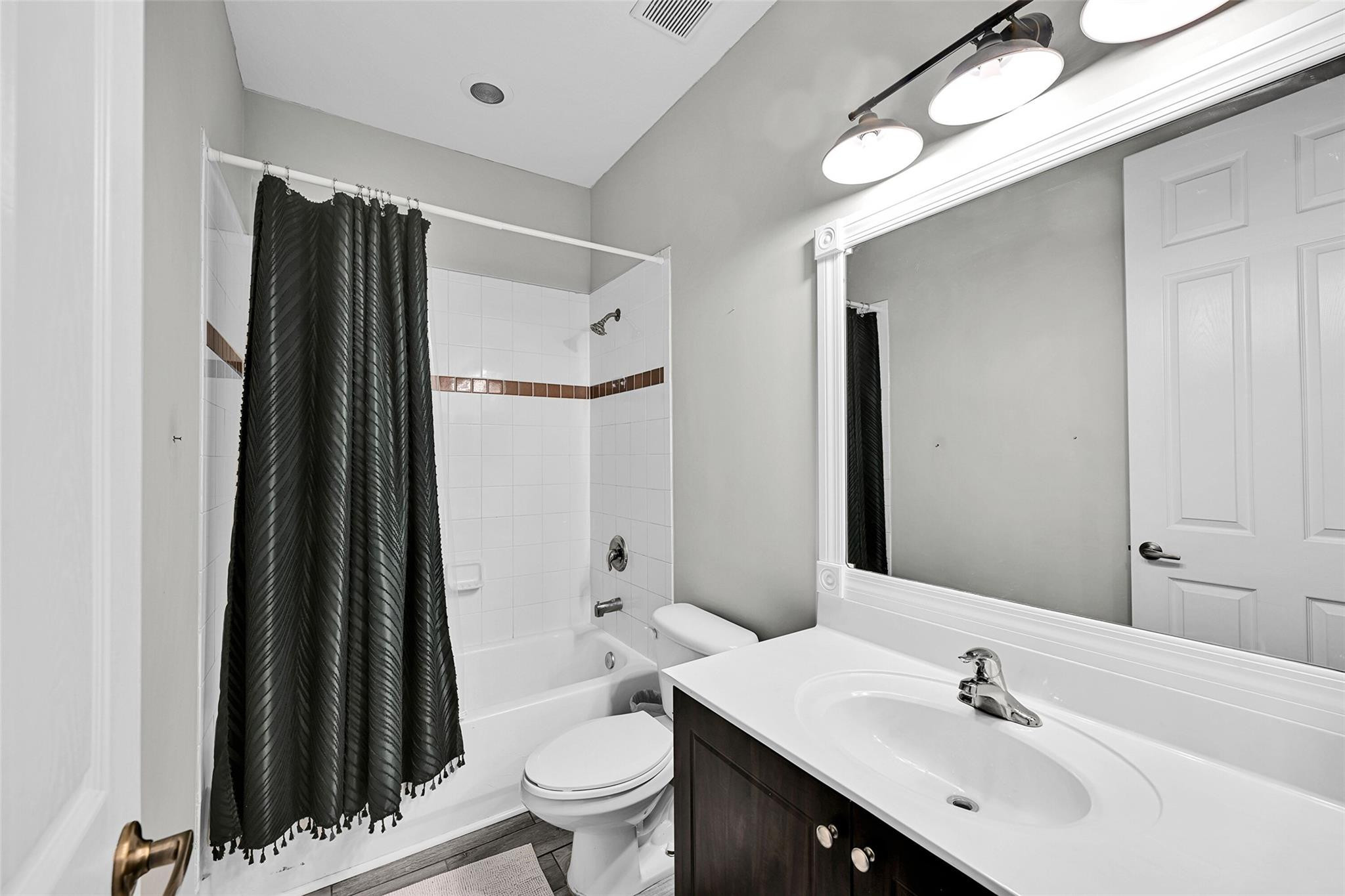 2851 Prospect Road, Unit 1202 Tamarac, FL 33309 - Photo 15 of 25 a bathroom with a sink a toilet a mirror and shower