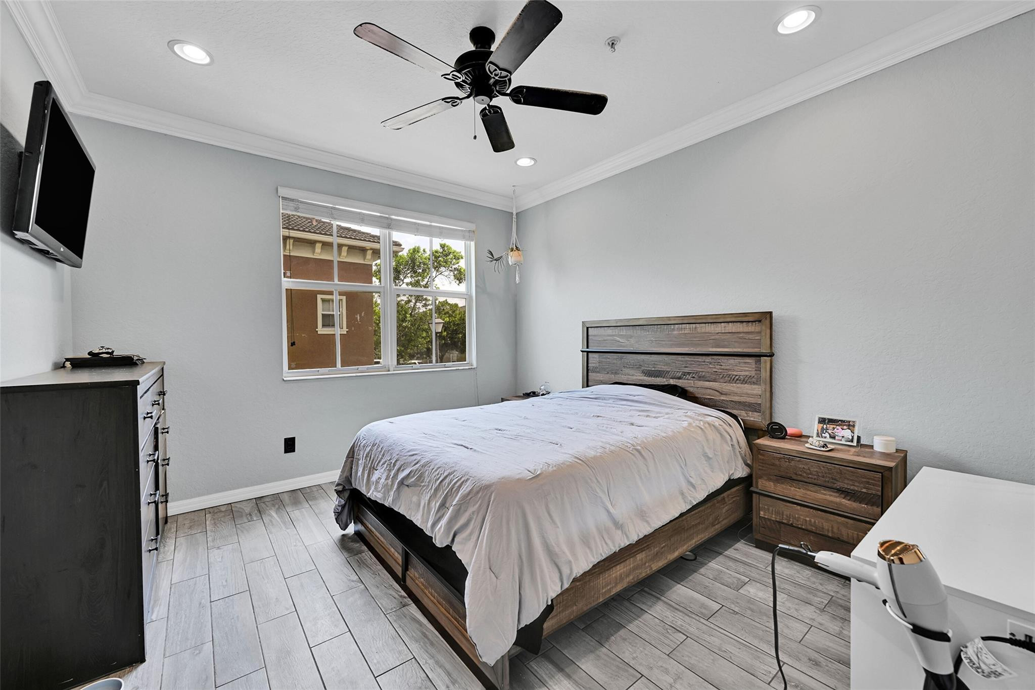 2851 Prospect Road, Unit 1202 Tamarac, FL 33309 - Photo 18 of 25 a bedroom with a bed and a flat screen tv