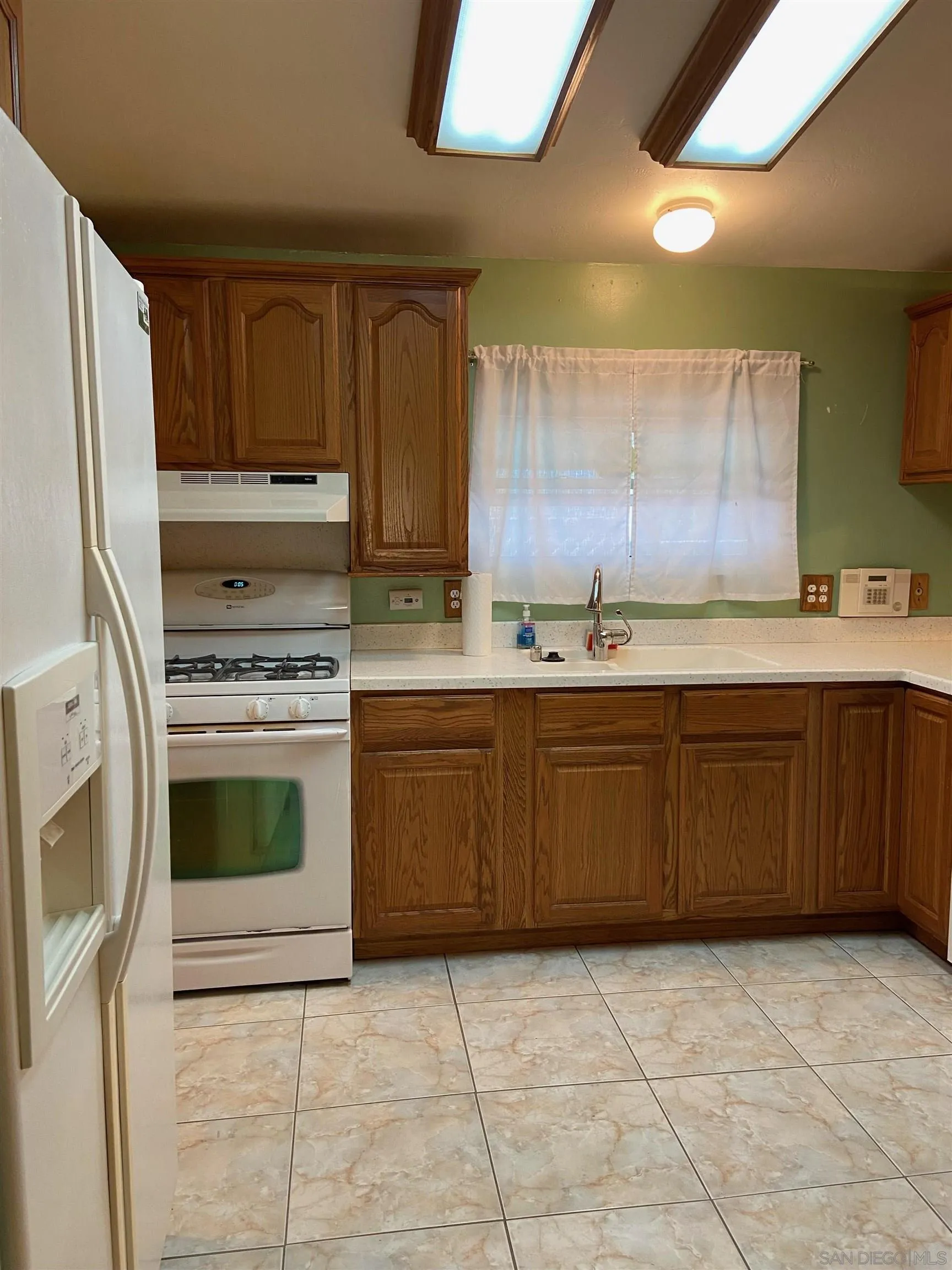 250 La Cresta Heights Road, Unit 18 El Cajon, CA 92021 - Photo 12 of 26 a kitchen with a cabinets and a stove top oven