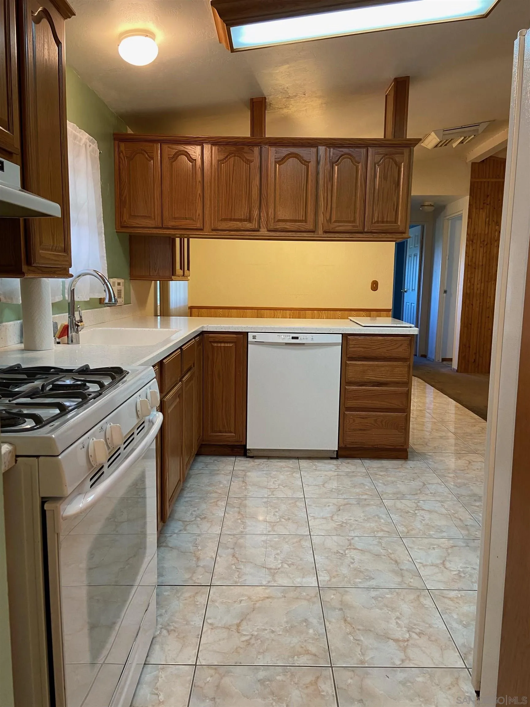 250 La Cresta Heights Road, Unit 18 El Cajon, CA 92021 - Photo 13 of 26 a kitchen with stainless steel appliances granite countertop a stove a sink and a microwave