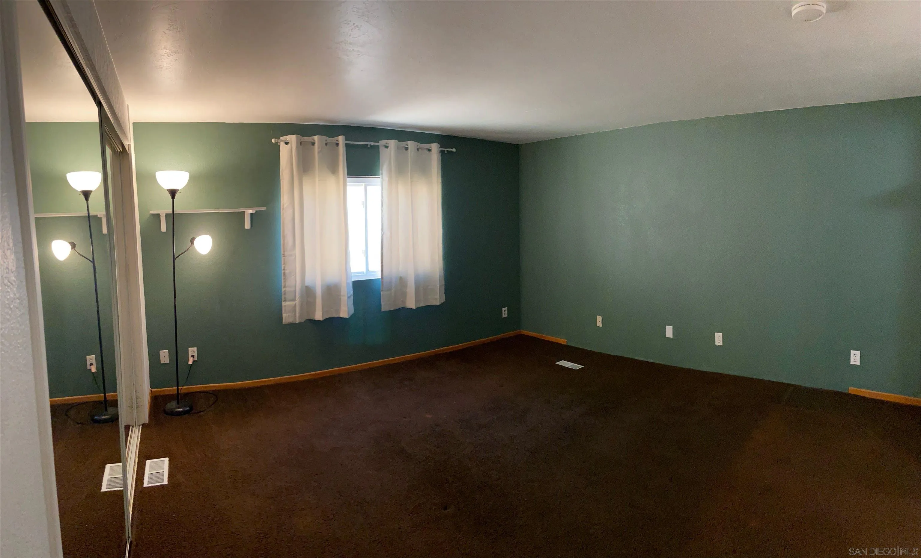 250 La Cresta Heights Road, Unit 18 El Cajon, CA 92021 - Photo 15 of 26 an empty room with wooden floor and windows