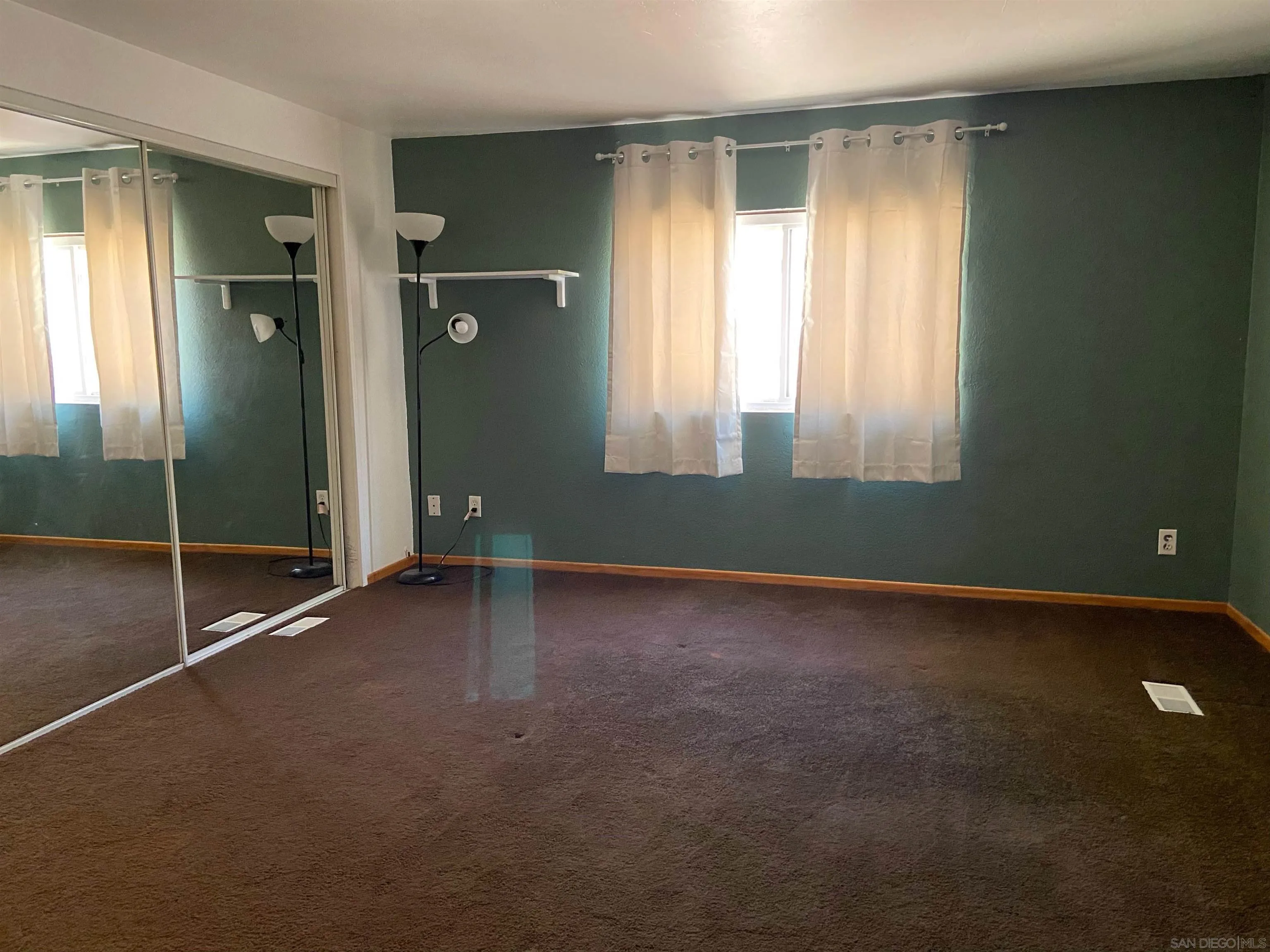 250 La Cresta Heights Road, Unit 18 El Cajon, CA 92021 - Photo 16 of 26 an empty room with windows and closet
