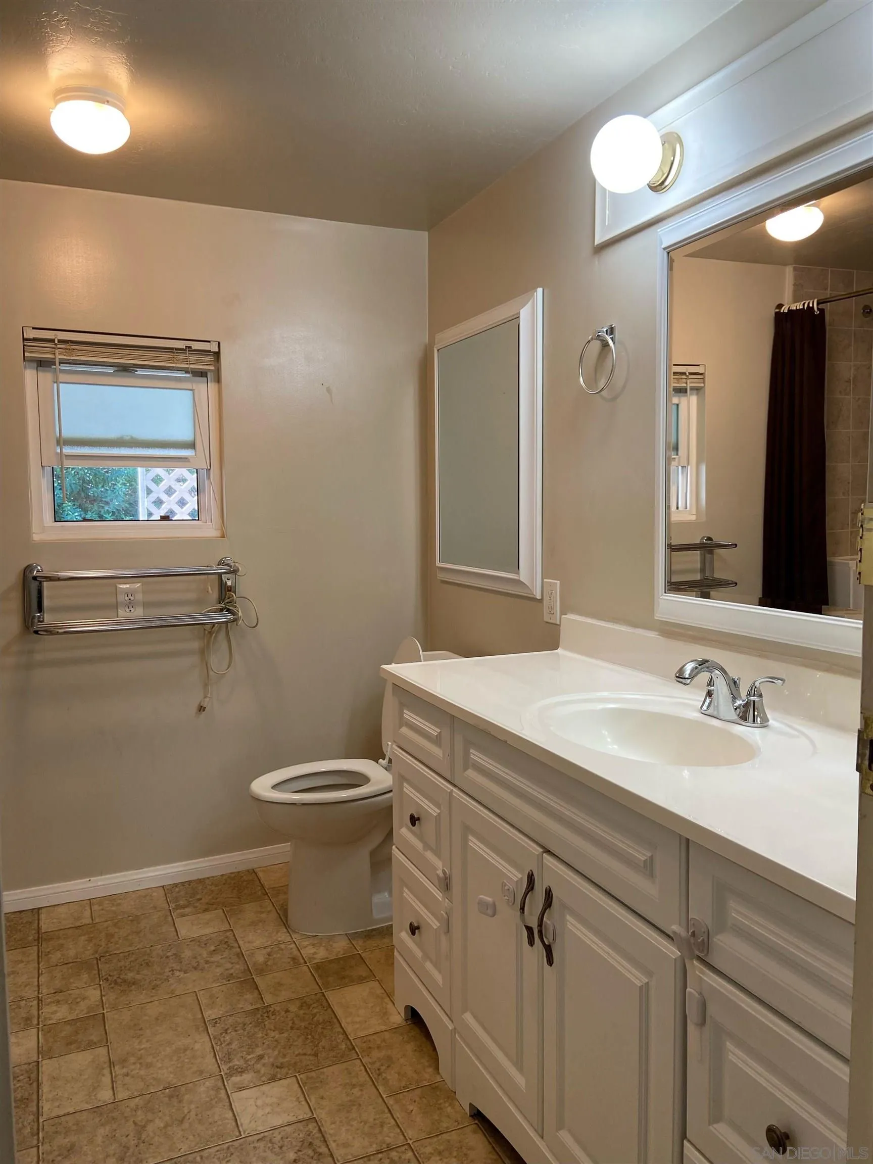 250 La Cresta Heights Road, Unit 18 El Cajon, CA 92021 - Photo 18 of 26 a bathroom with a granite countertop toilet sink and mirror