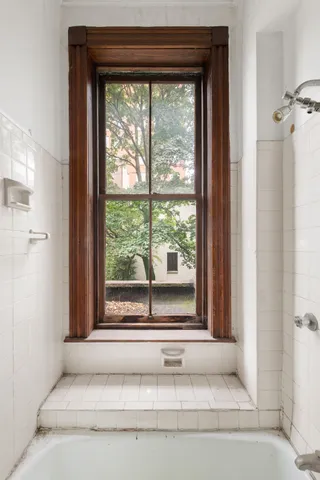 a white bath tub sitting in front of a window