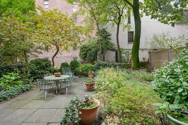 a view of a backyard with sitting area and garden