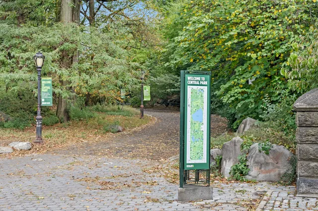 a sign board with yard in the back