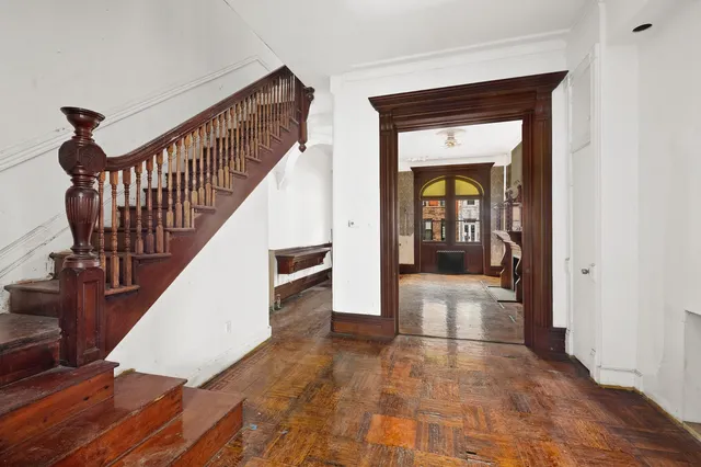 a view of an empty room with window and fire place