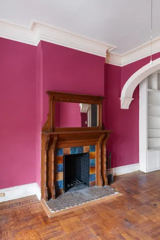 a view of an empty room with a fireplace