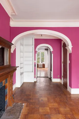 a view of an empty room with a fireplace and a fireplace