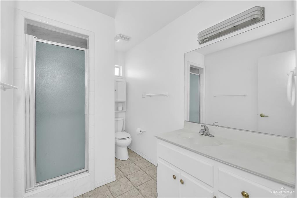 2002 Meadow Way Drive Mission, TX 78572 - Photo 12 of 20 a bathroom with a sink a toilet and shower