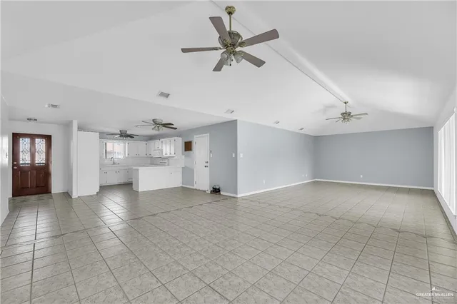 a view of a livingroom with a ceiling fan and window