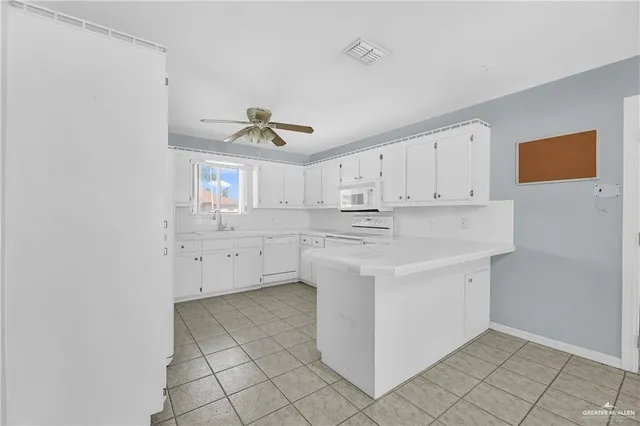 a kitchen with a sink cabinets and window