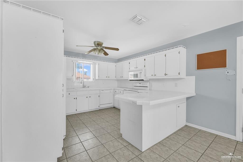 2002 Meadow Way Drive Mission, TX 78572 - Photo 9 of 20 a kitchen with a sink cabinets and window