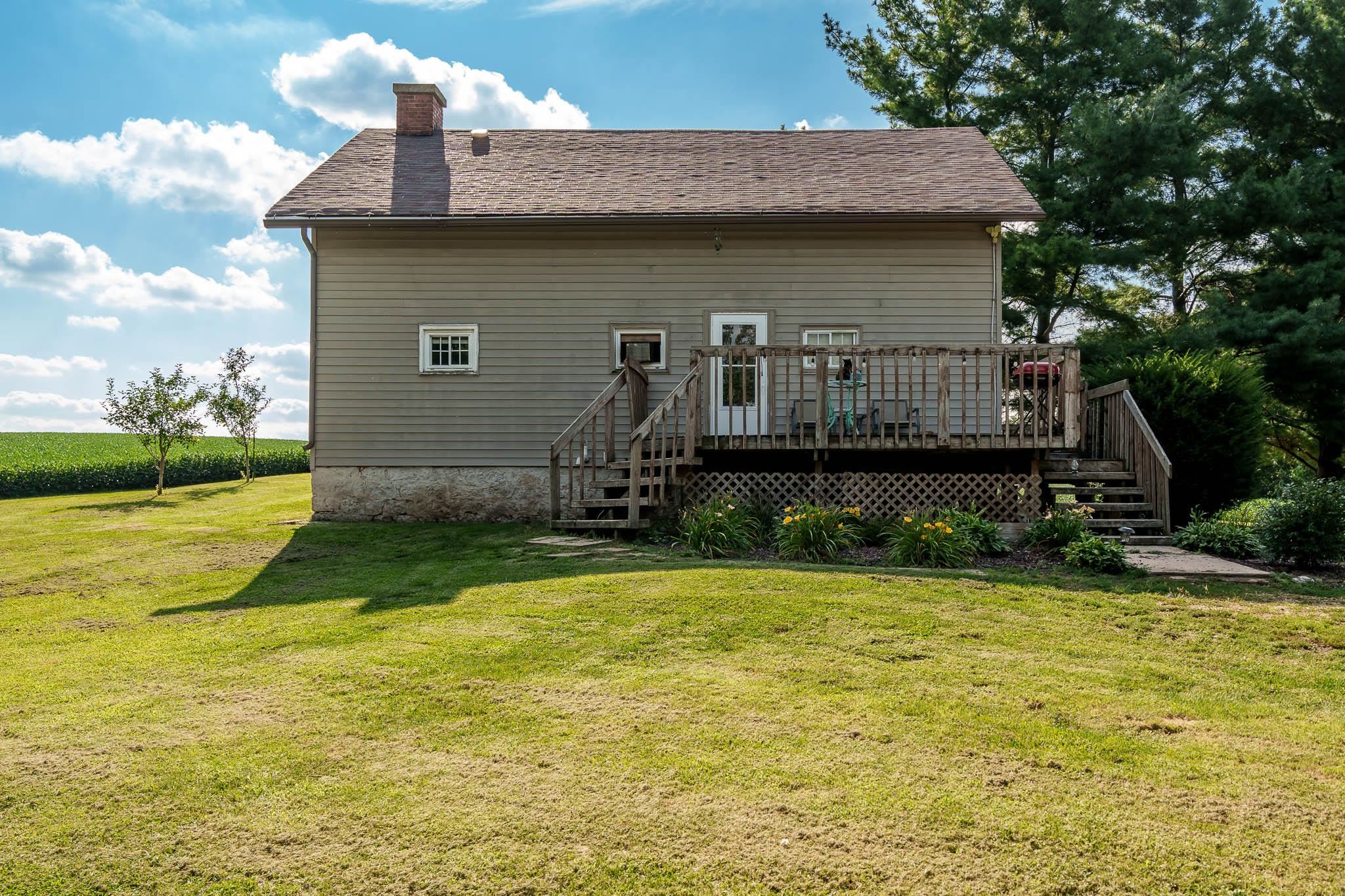 6913 West Wagner Road German Valley, IL 61039 - Photo 2 of 54 a front view of a house with garden